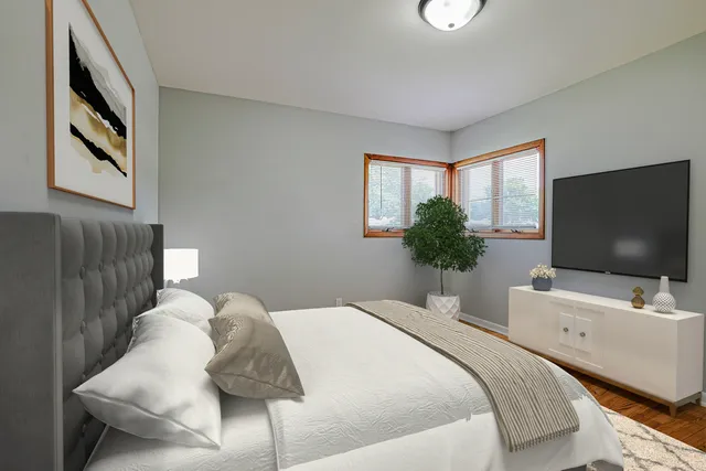 a bedroom with a bed and a flat screen tv