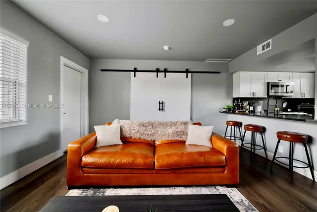 a bedroom with furniture and a rug