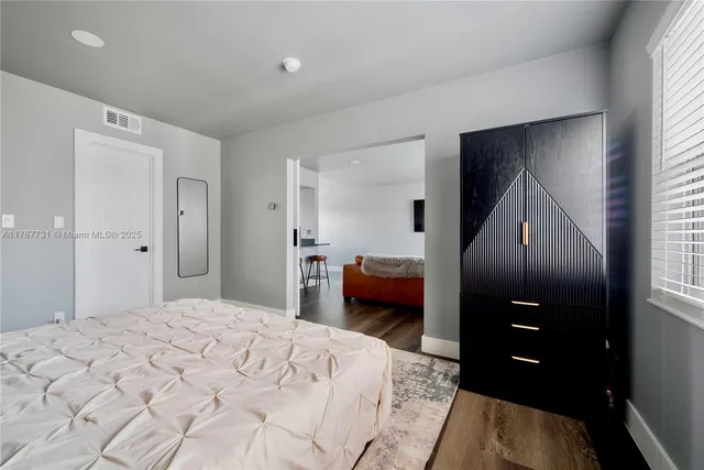 a bedroom with a bed and a walk in closet