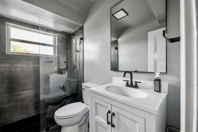 a bathroom with a sink toilet and shower