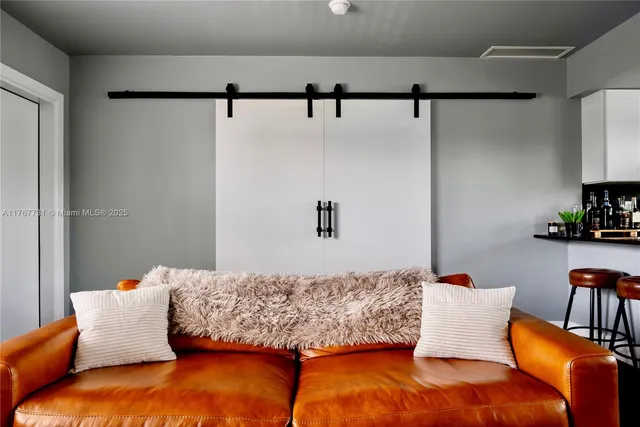 a bedroom with a bed and potted plant on the dresser