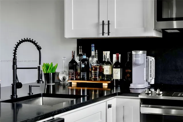 a kitchen with stainless steel appliances kitchen island granite countertop a stove a cabinets and a sink