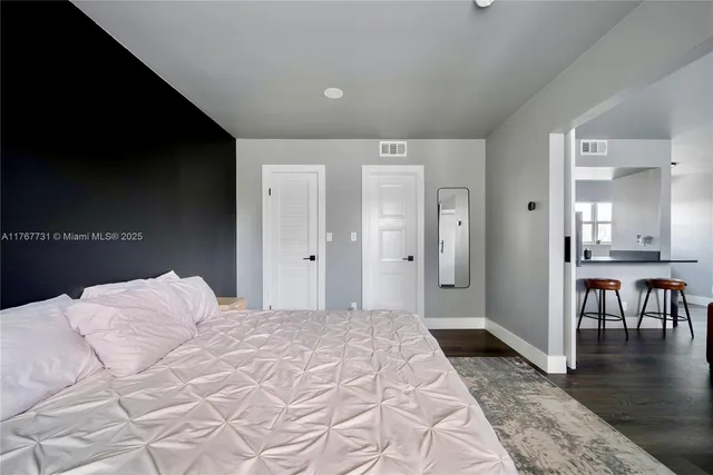 a bedroom with a bed and a view of bathroom