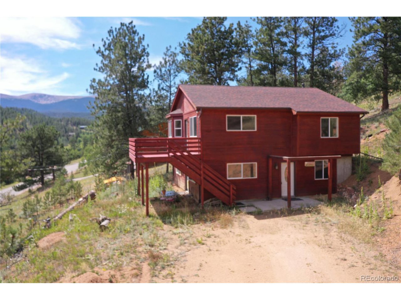 261 Wilkins Road Bailey, CO 80421 - Photo 1 of 39 a view of a house with a yard