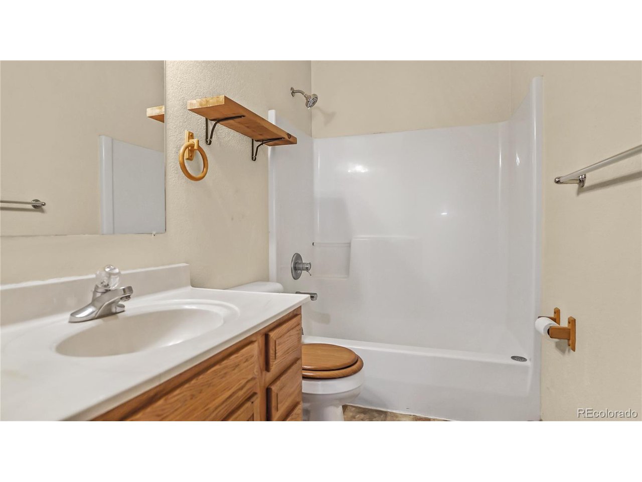 261 Wilkins Road Bailey, CO 80421 - Photo 12 of 39 a bathroom with a sink toilet a mirror and shower