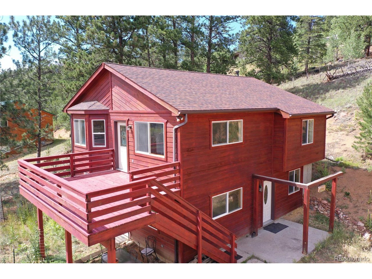 261 Wilkins Road Bailey, CO 80421 - Photo 2 of 39 a front view of a house with a yard