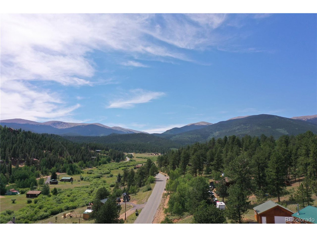 261 Wilkins Road Bailey, CO 80421 - Photo 25 of 39 a view of a lush green hillside and houses
