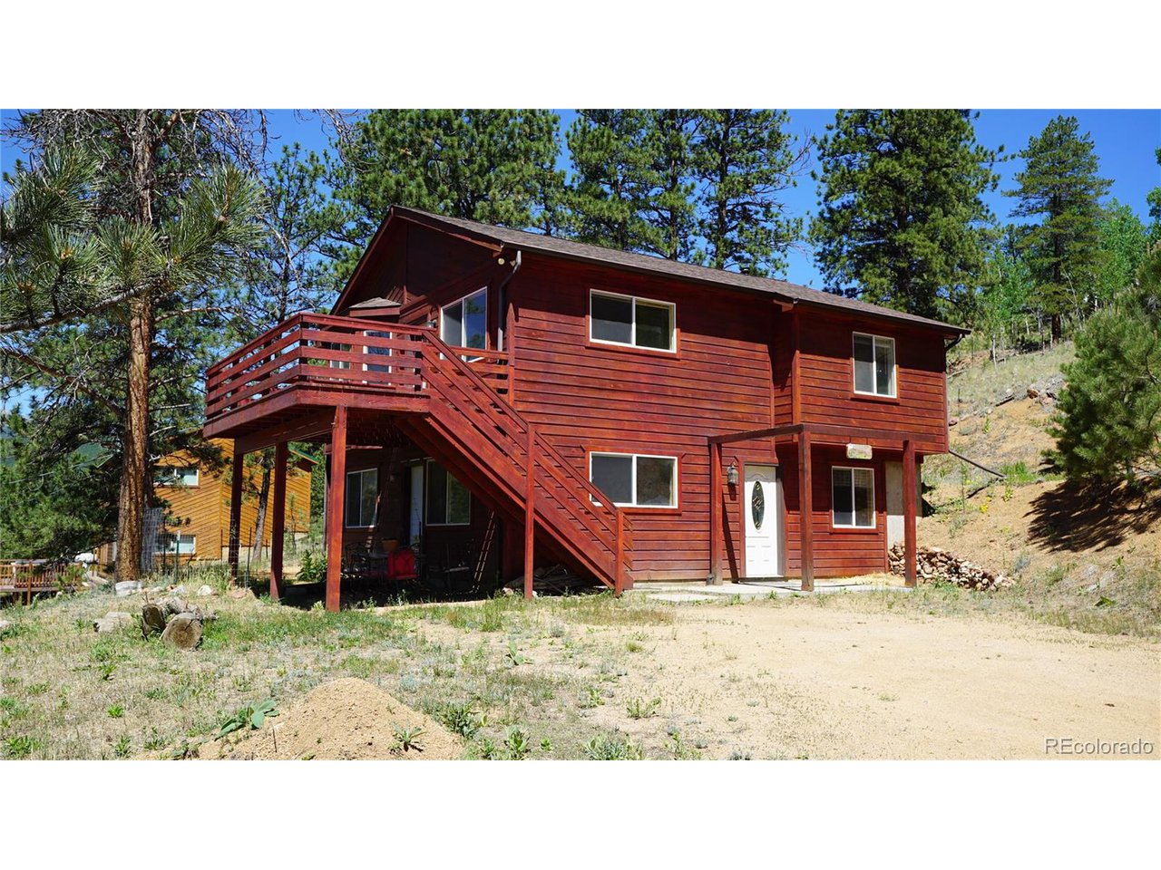 261 Wilkins Road Bailey, CO 80421 - Photo 28 of 39 a backyard of a house with wooden fence