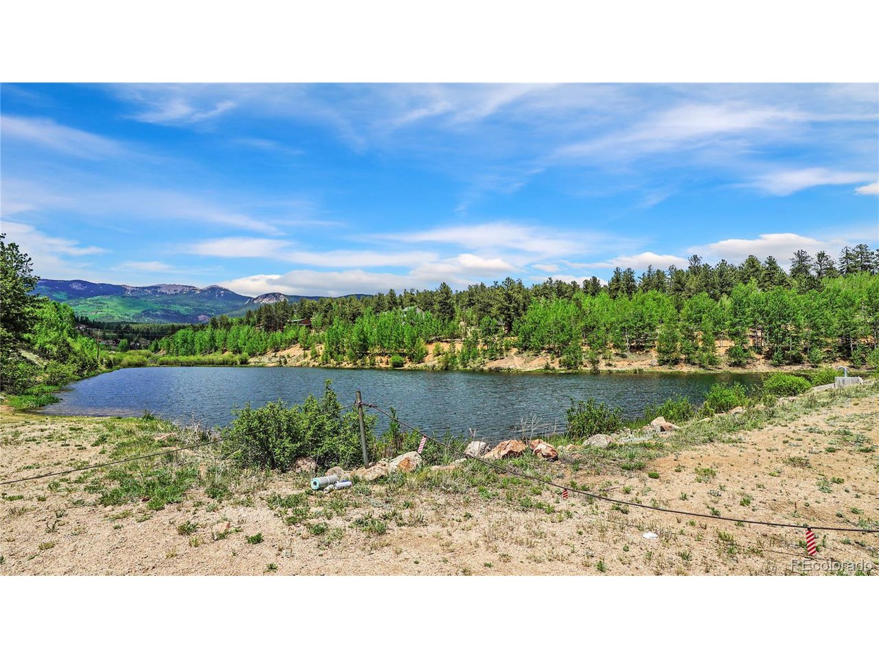 261 Wilkins Road Bailey, CO 80421 - Photo 37 of 39 a view of a lake with houses in the back