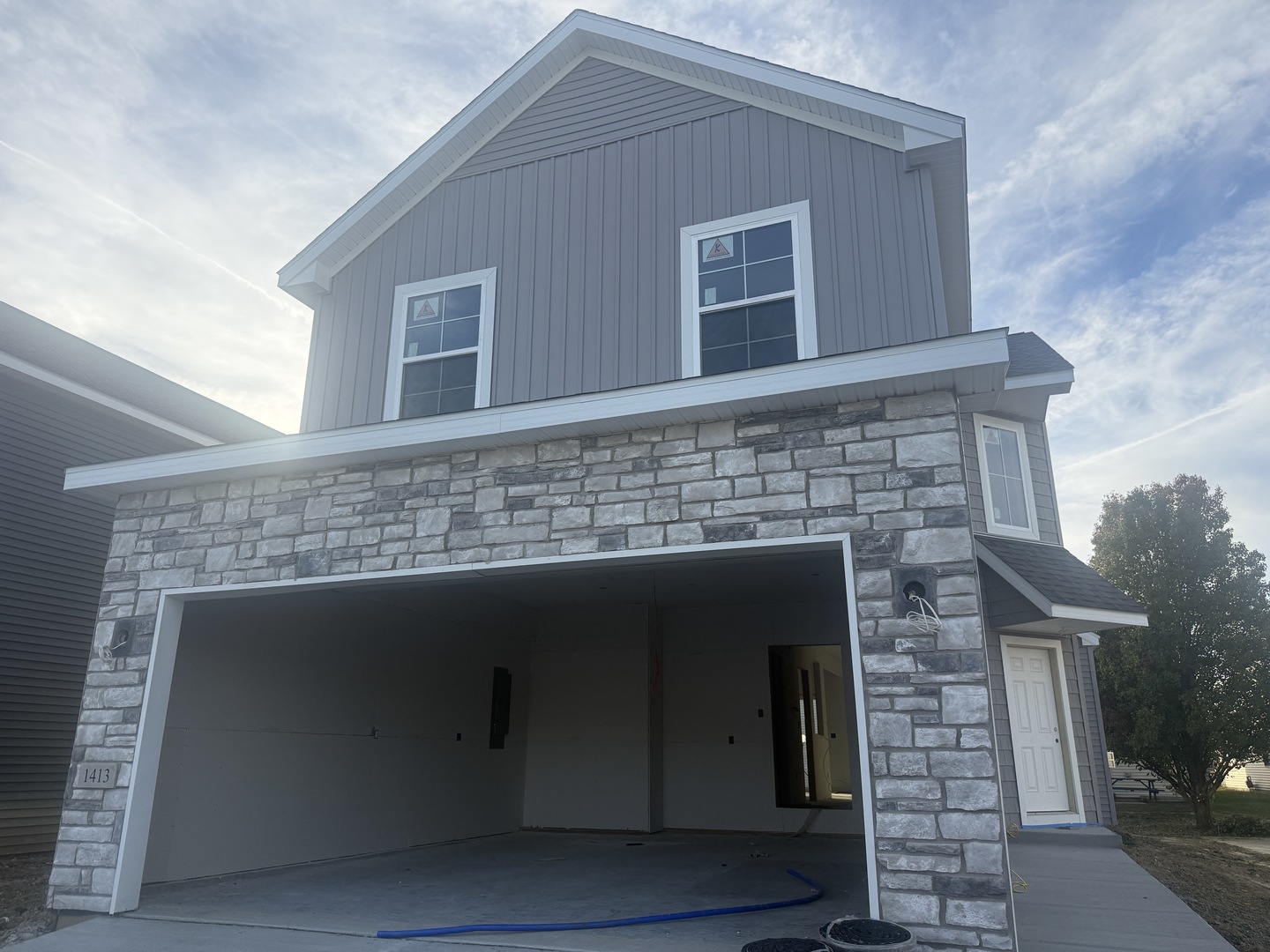 a front view of a house with plants