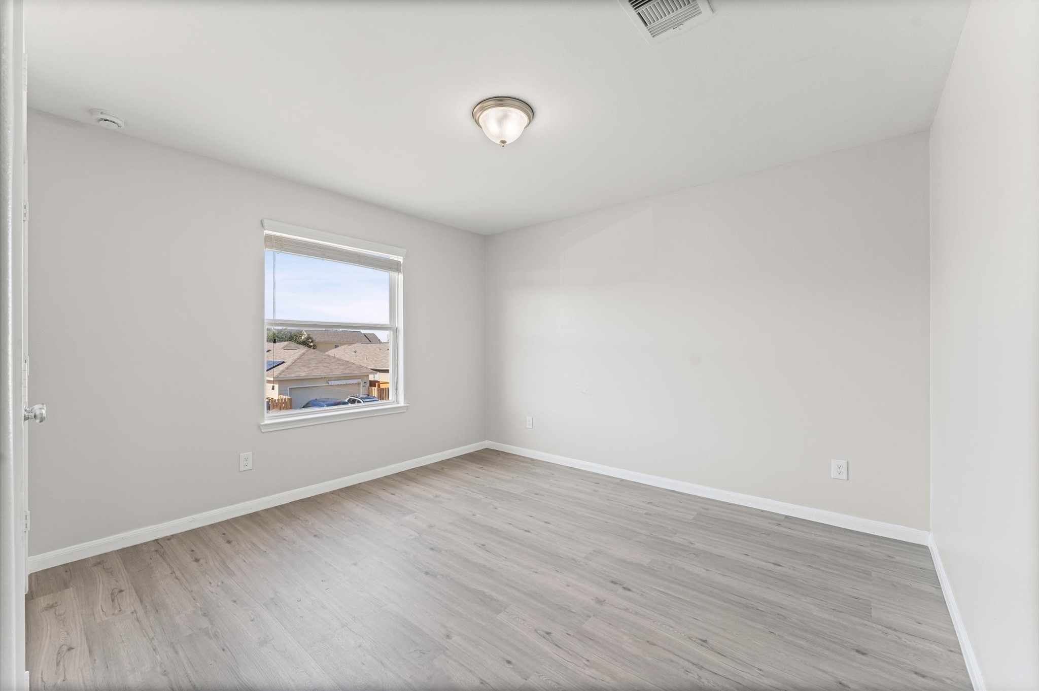 7018 Granite Terrace Lane Houston, TX 77083 - Photo 13 of 18 an empty room with wooden floor and windows