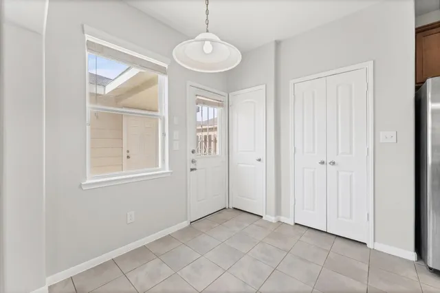 an empty room that has a window and wooden floor