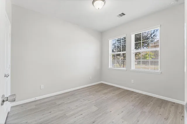 wooden floor in an empty room with a window