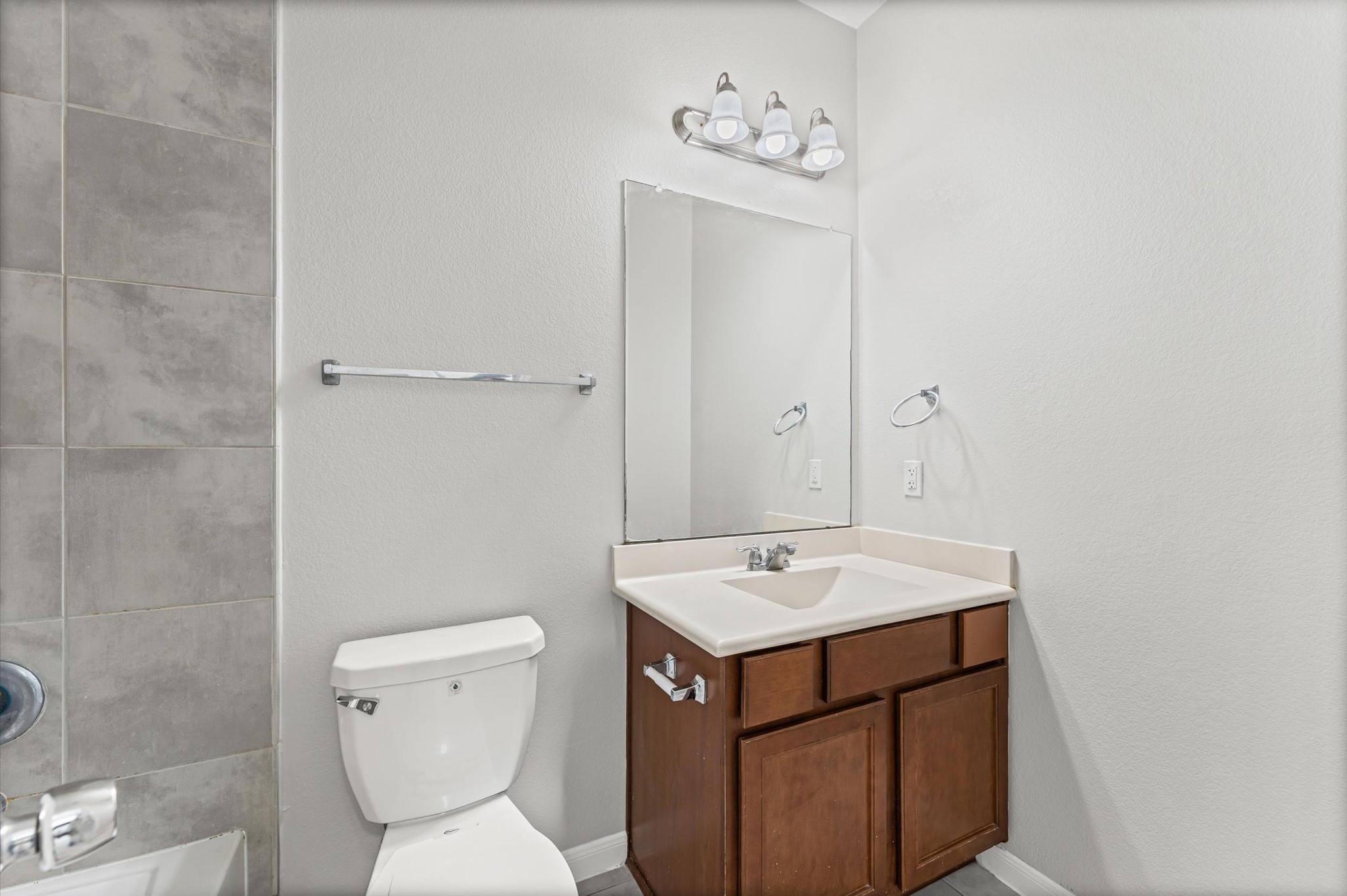 7018 Granite Terrace Lane Houston, TX 77083 - Photo 9 of 18 a bathroom with a toilet sink and mirror