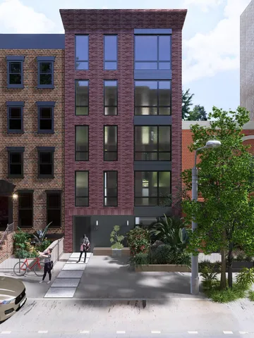 a brick building with a bench in front of it