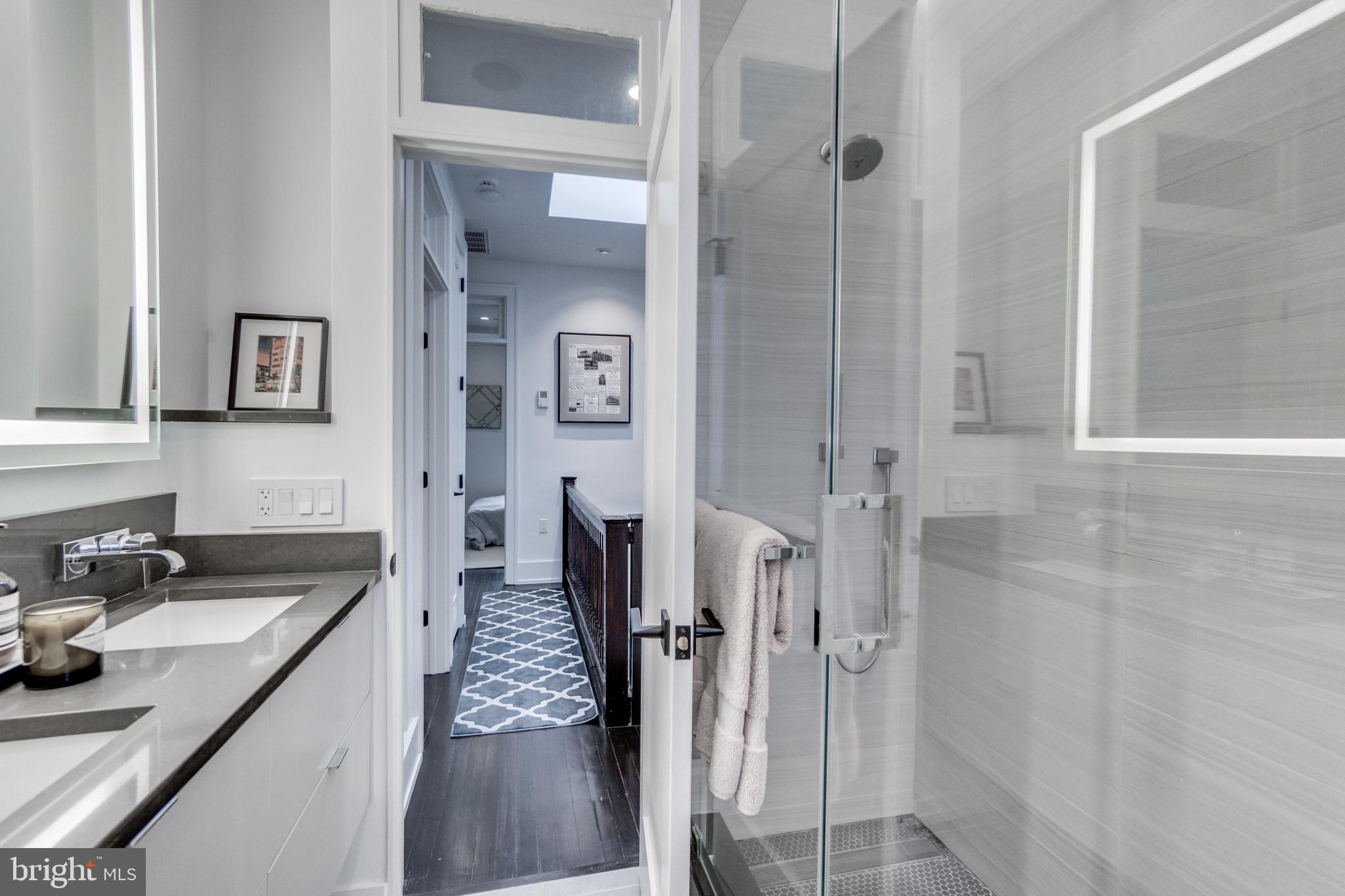 1009 Irving Street Northwest Washington, DC 20010 - Photo 26 of 33 Sleek modern bathroom with natural light.