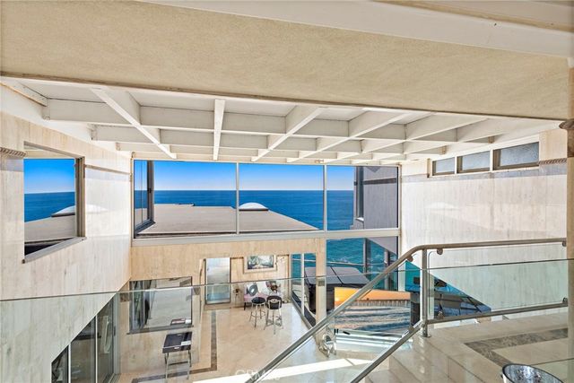 a kitchen with stainless steel appliances a dining table and chairs