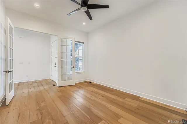 a view of wooden floor and windows in a room