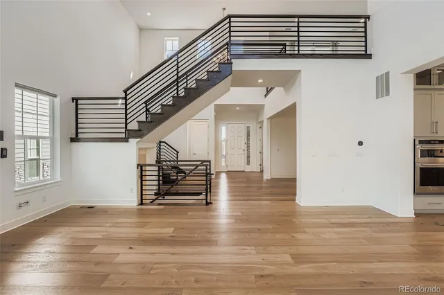 a kitchen with stainless steel appliances a stove top oven and a wooden floors