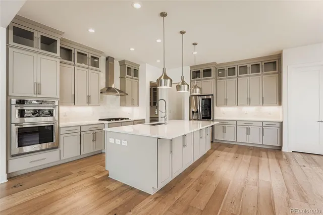 a kitchen with stainless steel appliances a stove sink and cabinets