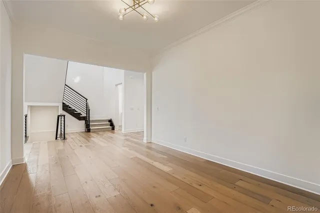 a view of a livingroom with wooden floor and a fireplace
