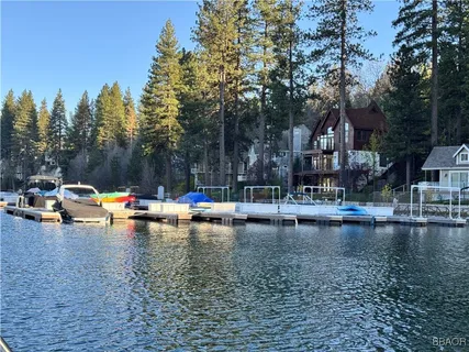 a view of pool with umbrella and trees