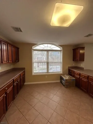 a kitchen with stainless steel appliances granite countertop a stove and a refrigerator