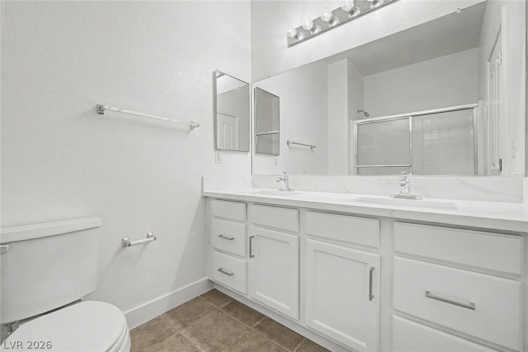 835 Entrada Ridge Avenue Henderson, NV 89012 - Photo 26 of 34 Double vanity and a full-width mirror complete this tidy bathroom.