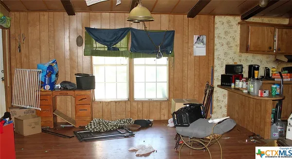 a bedroom with a bed and a lamp on dresser