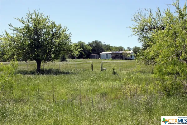a backyard of a house with yard and outdoor seating