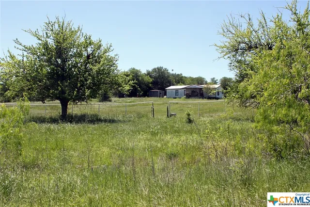 a backyard of a house with yard and outdoor seating