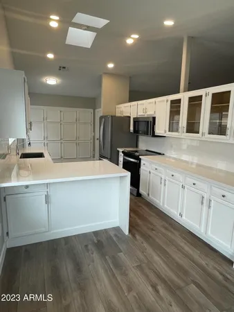 a kitchen with a sink and cabinets