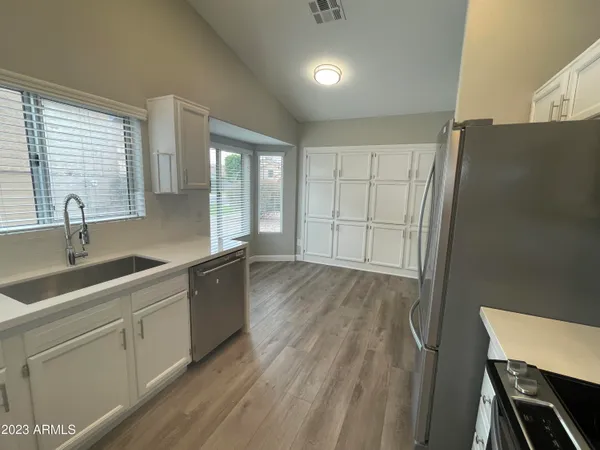 a kitchen with sink and cabinets