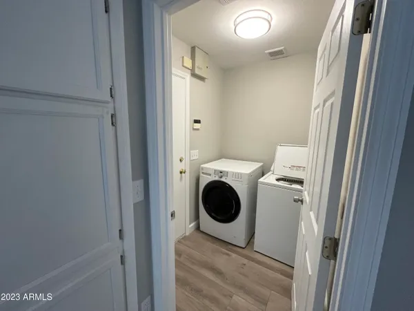a view of a hallway with washer and dryer