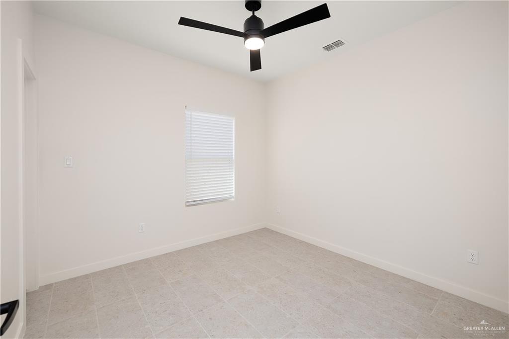 11501 North 25th Street, Unit 2 McAllen, TX 78504 - Photo 15 of 22 a room with a window and a ceiling fan