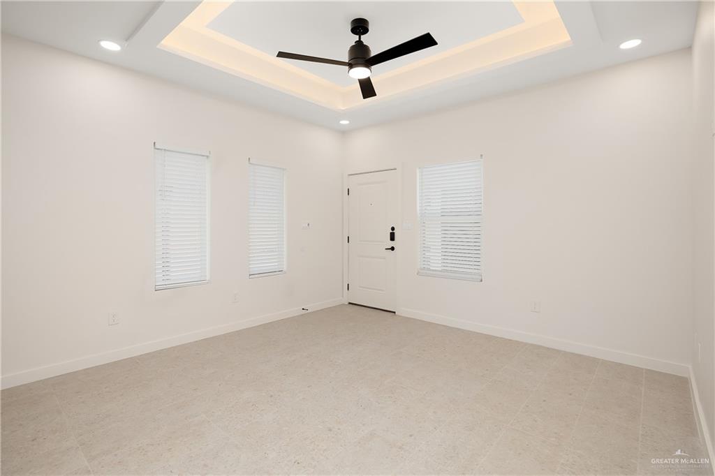 11501 North 25th Street, Unit 2 McAllen, TX 78504 - Photo 4 of 22 an empty room with a ceiling fan and a window