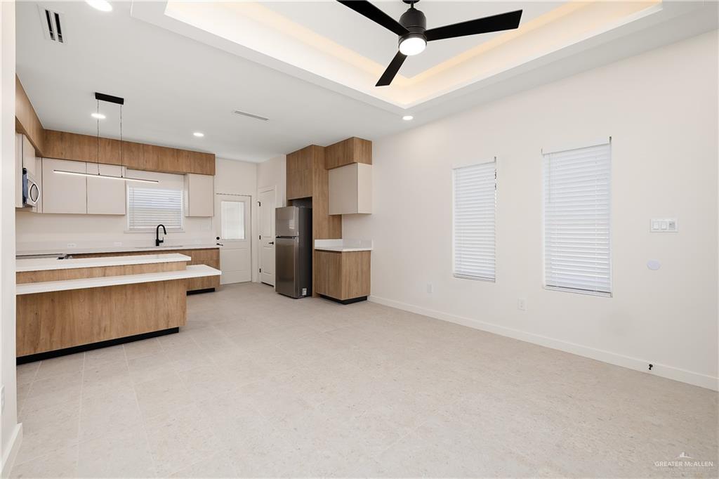 11501 North 25th Street, Unit 2 McAllen, TX 78504 - Photo 5 of 22 a kitchen with stainless steel appliances a refrigerator a sink dishwasher with a stove and cabinets