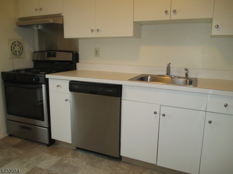 181 Long Hill Road, Unit 8 Little Falls, NJ 07424 - Photo 11 of 15 a kitchen with a sink and a stove