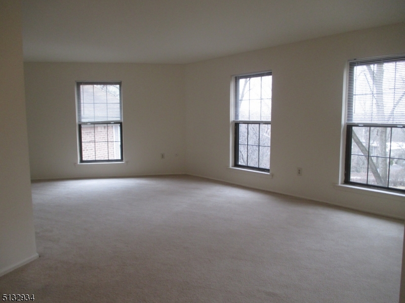 181 Long Hill Road, Unit 8 Little Falls, NJ 07424 - Photo 5 of 15 an empty room with windows