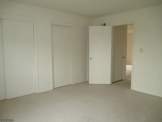 a kitchen with a refrigerator sink and cabinets