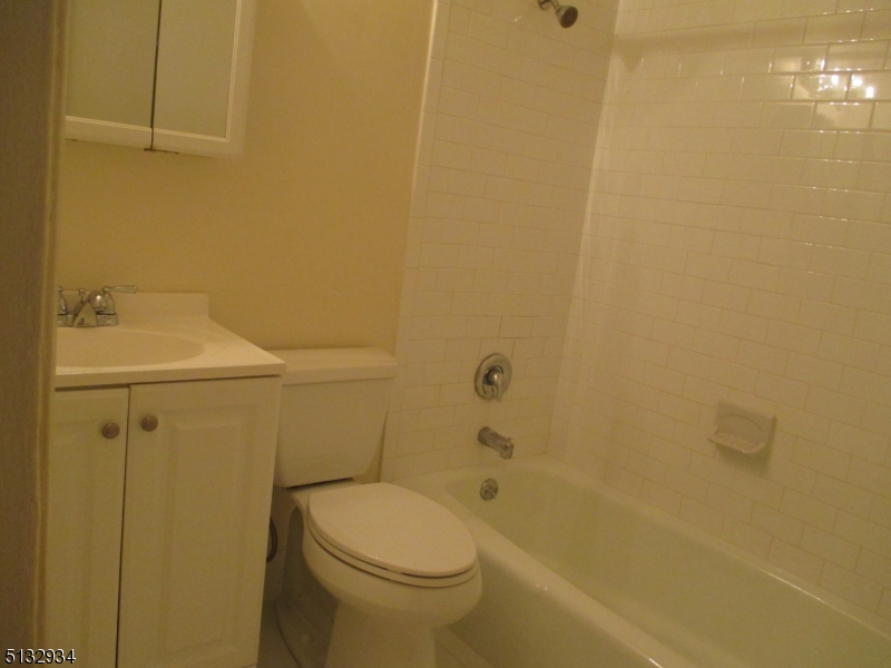181 Long Hill Road, Unit 8 Little Falls, NJ 07424 - Photo 8 of 15 a bathroom with a sink a toilet and shower