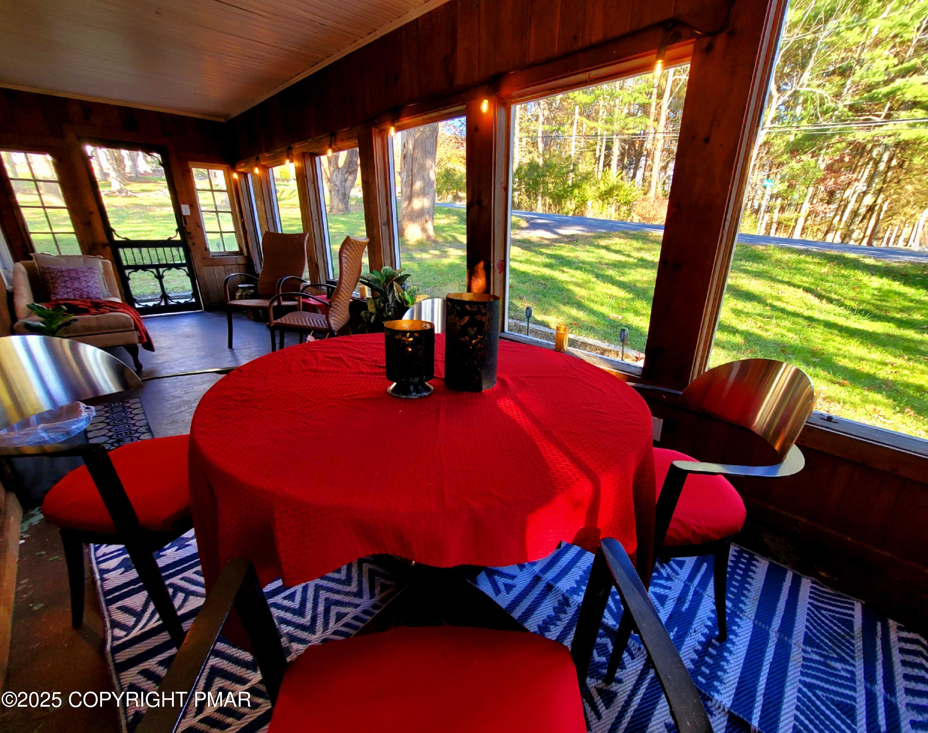 2735 Highway 390 Canadensis, PA 18325 - Photo 15 of 55 a view of a dining room with furniture large windows and wooden floor