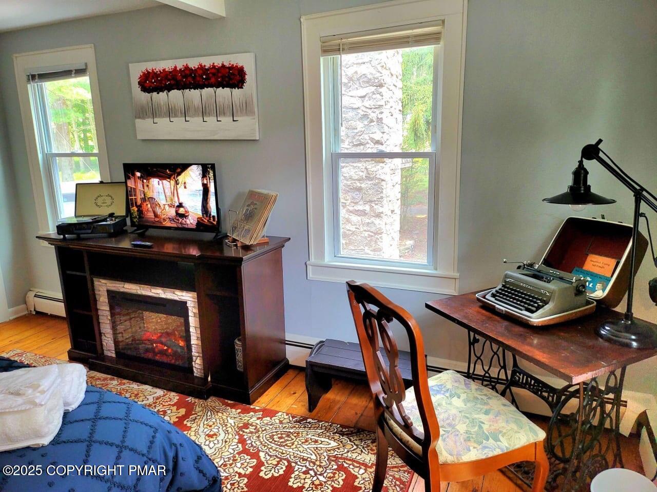 2735 Highway 390 Canadensis, PA 18325 - Photo 19 of 55 a living room with a fireplace wooden floor and a fireplace