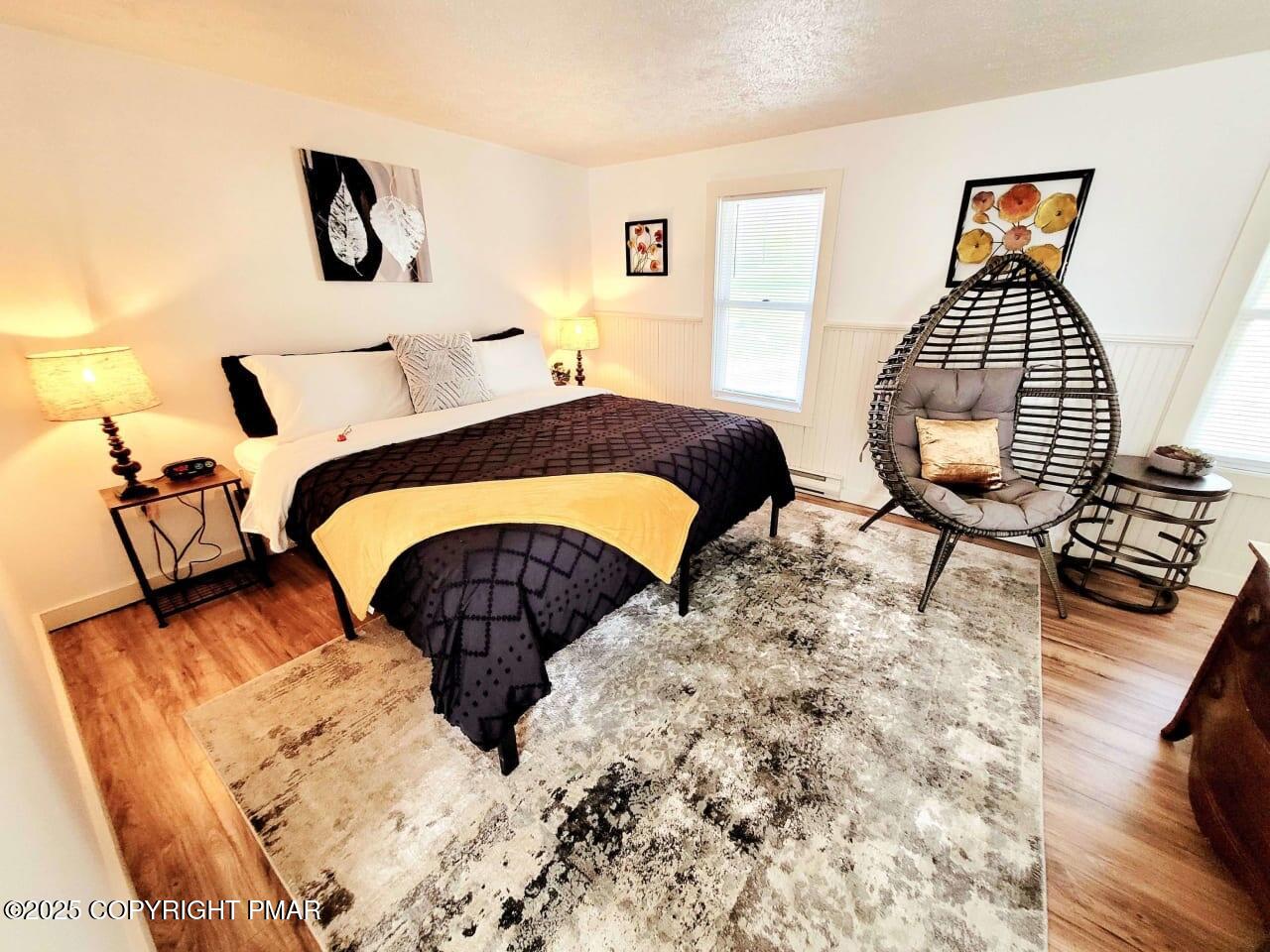 2735 Highway 390 Canadensis, PA 18325 - Photo 23 of 55 a bedroom with a bed and dresser with wooden floor