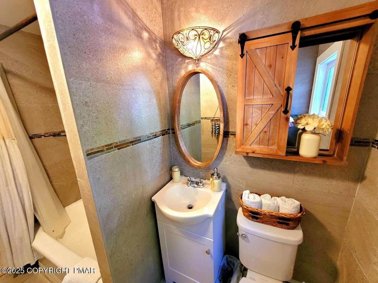 2735 Highway 390 Canadensis, PA 18325 - Photo 24 of 55 a bathroom with a sink a mirror a toilet and a window