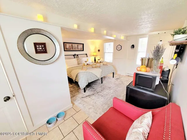 a living room with furniture and a floor to ceiling window