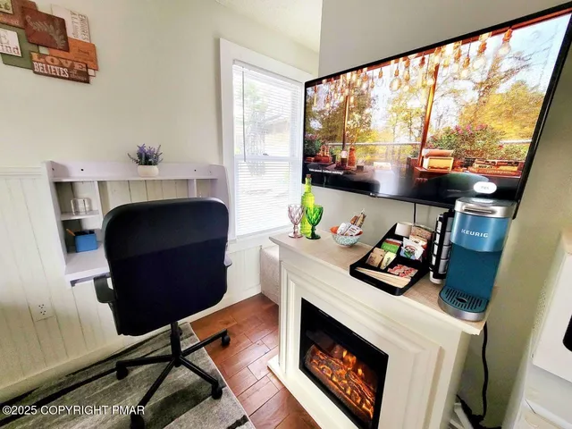 a view of a room with wooden floor