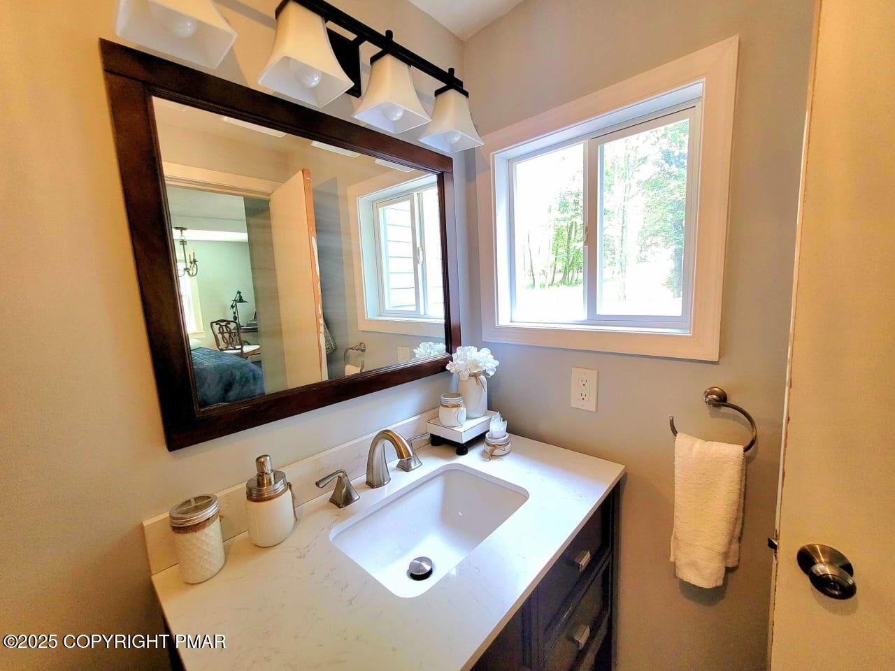 2735 Highway 390 Canadensis, PA 18325 - Photo 43 of 55 a bathroom with a sink vanity and mirror