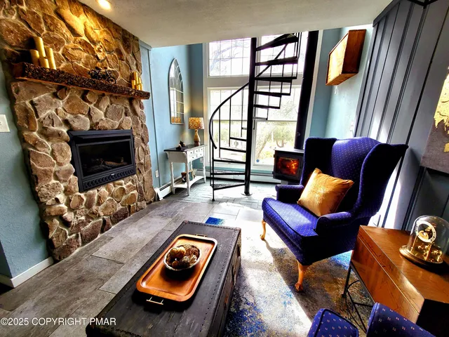 a living room with furniture a rug and a window