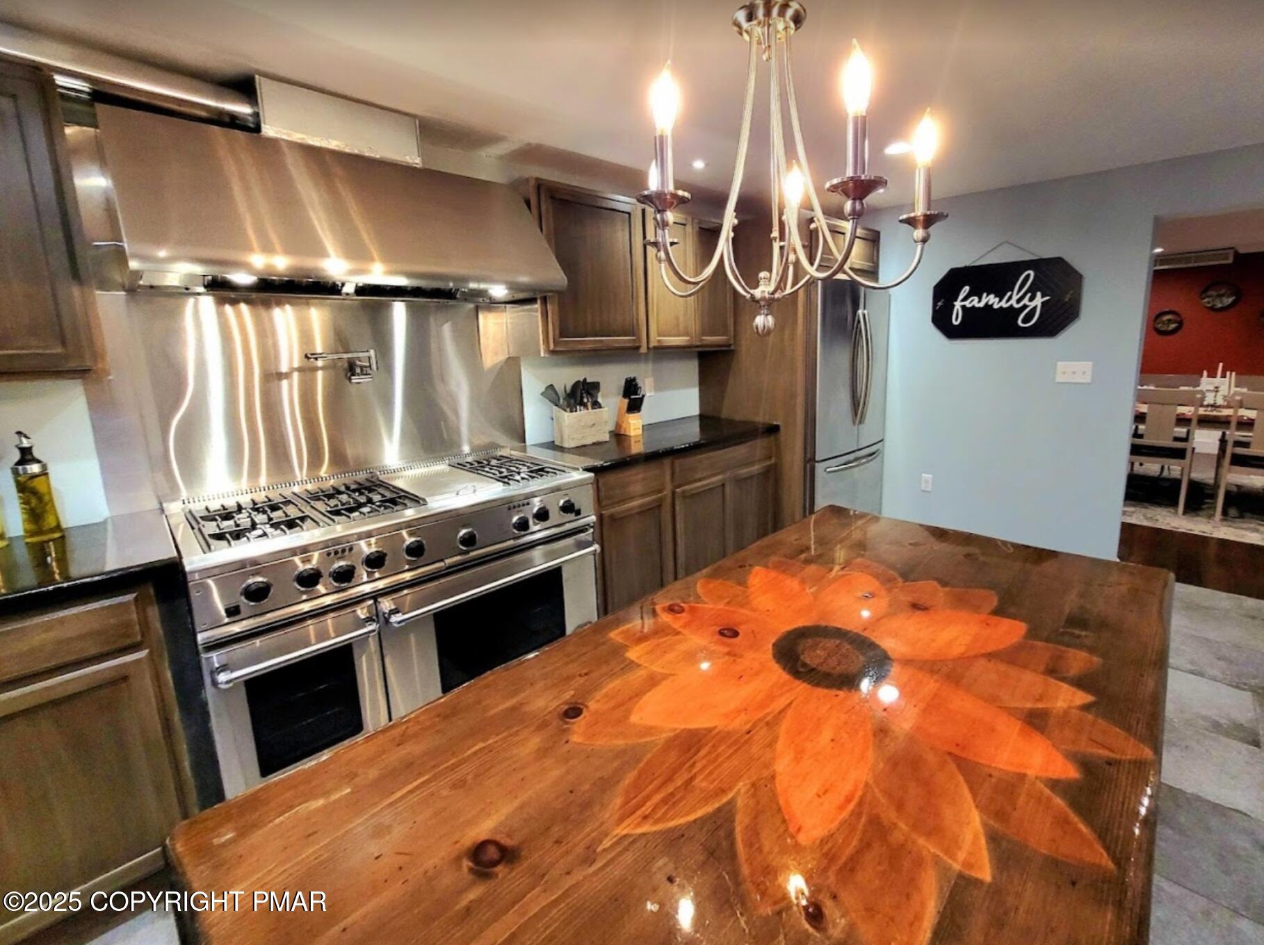 2735 Highway 390 Canadensis, PA 18325 - Photo 9 of 55 a kitchen with stainless steel appliances granite countertop a stove a sink and a refrigerator